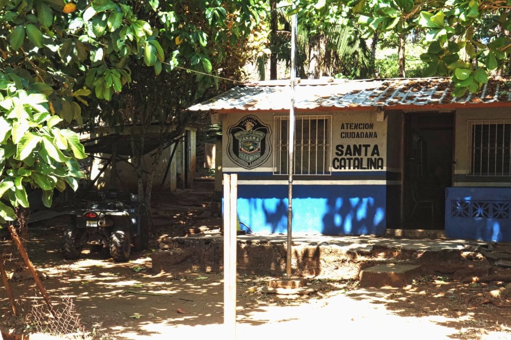 Santa Catalina police station, shaded under trees, an ATV parked to the left.
